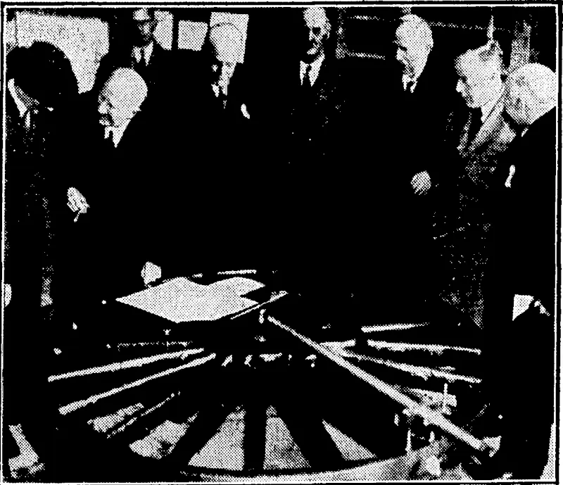 Sport and General" Photo. SCIENCE AND INDUSTRY.Â—Lord Rutherford of Nelson opened the new L.M.S. Research Laboratories at Derby on December 10, where scientific research ' will be applied to the maintenance and upkeep of railway services. Third from left onivards, Sir Josiah Stamp, Sir William Bragg, Lord Rutherford, and Sir James Jeans looking at a circularity test on a locomotive wheel. (Evening Post, 10 January 1936)
