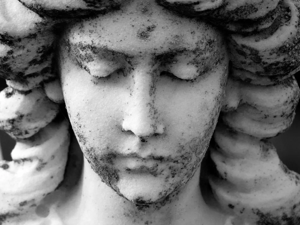 Sadness in the angel's face.