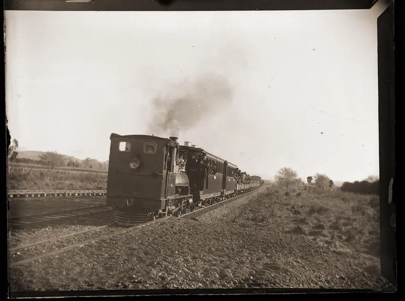 Train with passengers, possibly at opening of Te Karaka station.