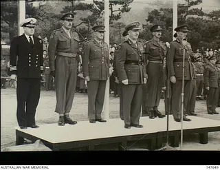Kure, Japan. 1951-11-10. Officers on the Saluting Dais during the farewell parade to British Commonwealth Occupation Force (BCOF) troops held at Anzac Park. Left to right: Commander C. J. ..