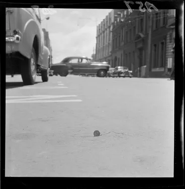 Image: Threepence coin used to demonstrate the size of a crack in Customhouse Quay, Wellington