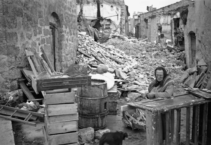Woman alongside the ruins of her home, Gessopalena, Italy