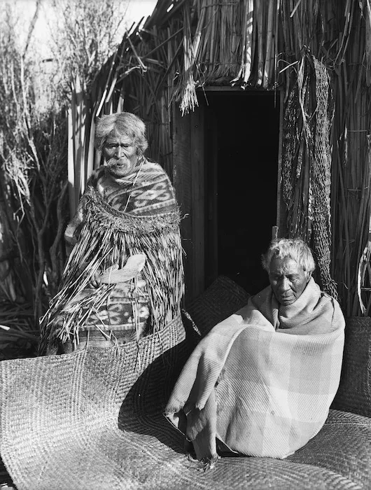 Maori men at the model pa during the New Zealand International Exhibition, Christchurch
