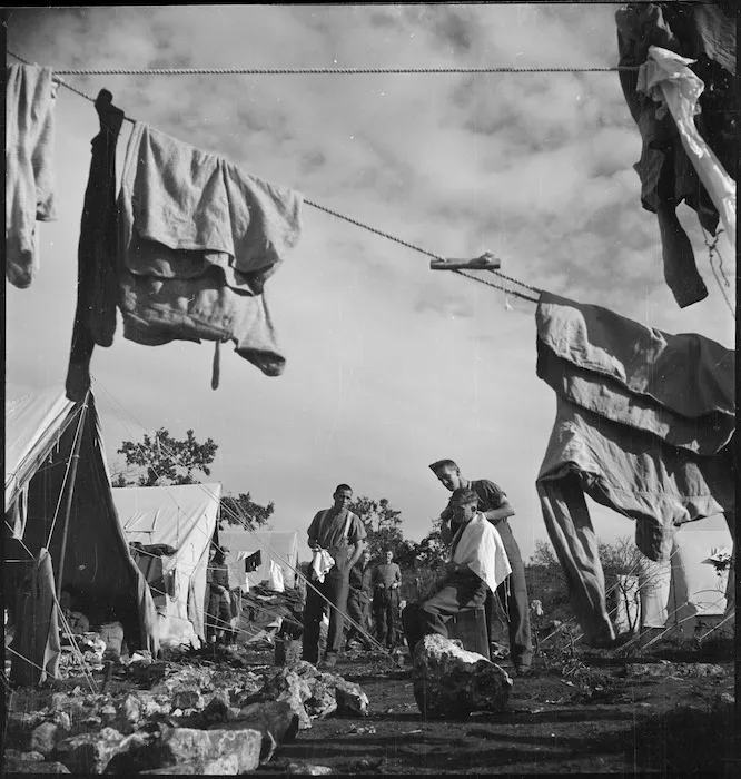 Amateur barber at the New Zealand Advance Base Camp in Italy, World War II - Photograph taken by M D Elias