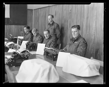 Image: Sergeant D D Whitlock instructs touch typing to LAC W W Matthews, LAC J J Thomson, LAC D J McNair and Corporal K J Gilmour, Hobsonville Technical Training School