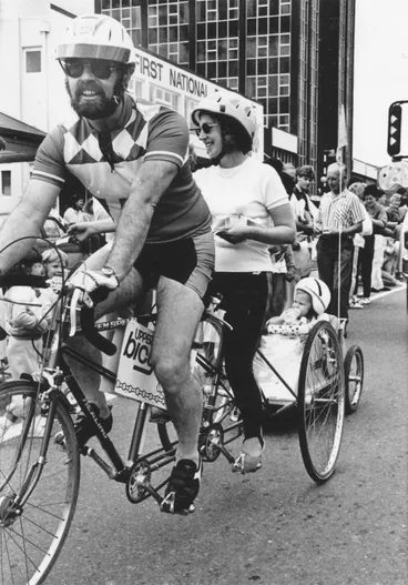 Image: Christmas parade 1987; David Butler and Sheila Radcliffe on tandem tricycle with son Chase in trailer.