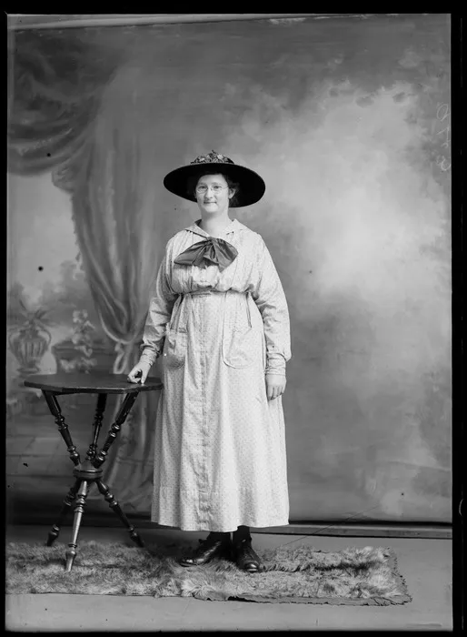 Studio portrait of an unidentified woman, wearing spectacles and a wide-brimmed hat, possibly Christchurch district