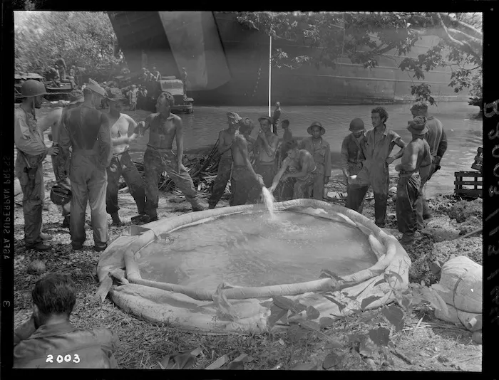 Fresh water being brought ashore from tank landing ship, Nissan Island