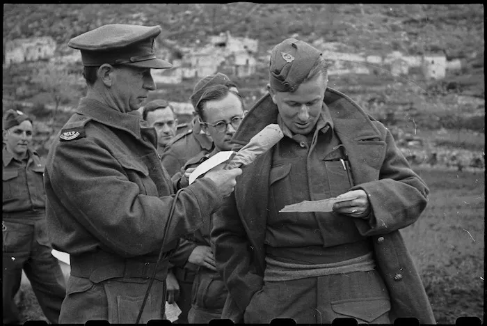 Archibald Curry, NZ Broadcasting Unit, recording a message from a New Zealander on the Cassino Front, Italy - Photograph taken by George Bull