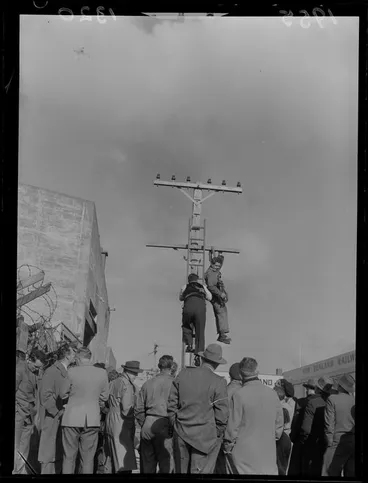 Image: Mr Athol Hollis of Palmerston North demonstrates a new safety belt that he designed for linesmen, New Zealand Railway yards, Wellington