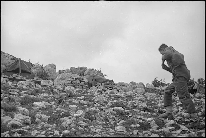 E G Wilson walking over hilly country to relieve at an observation post, Italy, World War II - Photograph taken by George Kaye