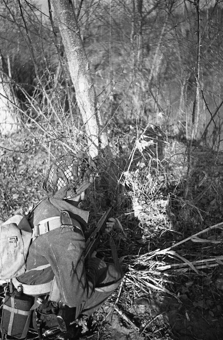 Kaye, George, 1914- : A NZ infantryman makes use of natural cover in the forward area of the Italian front near Faenza