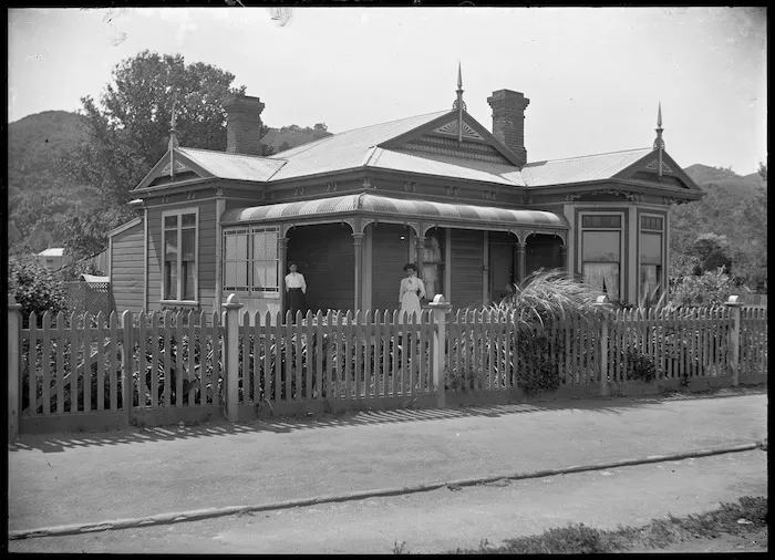 Bungalow with verandah and paling fence.