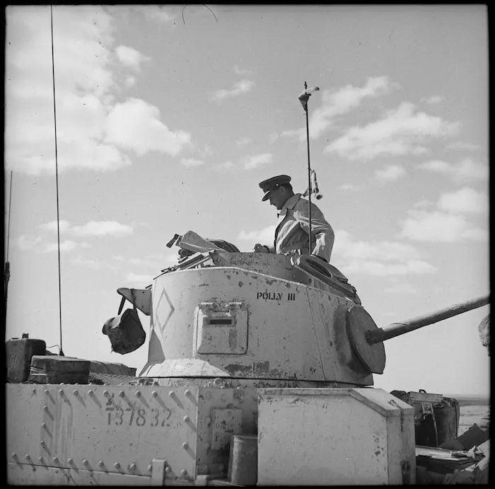 Commanding officer General Freyberg studying map on turret of his Honey tank during Axis retreat after Alamein, World War II - Photograph taken by H Paton