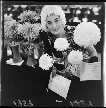Image: 'Fashion and flower show at the Town Hall' (caption) witn Champion of champions bloom of the National Chrysanthemum Society