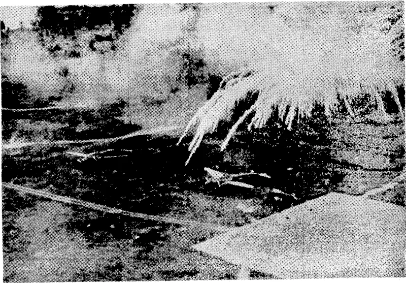 Incendiary phosphorus bombs, dropped by Hailed Stales aircraft, burst and scatter destruction over grounded Japanese bomber and fighter planes on Lakunai airfield, Rabaul, New Ireland. (Evening Post, 31 May 1944)