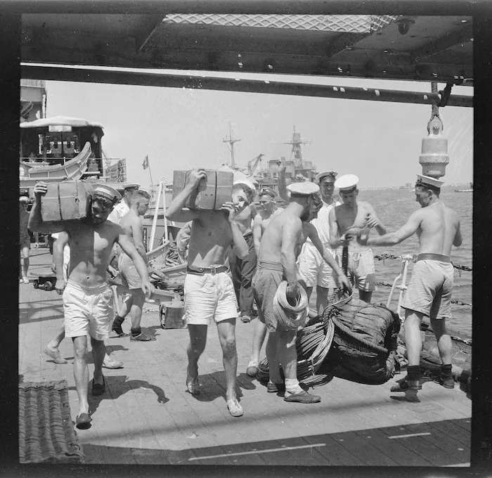 Sailors carrying stores below deck on board the HMS Leander during World War 2