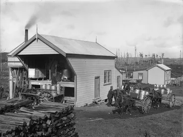 Image: Men loading horse-drawn carts with milk cans ready for transport to a factory in the Taranaki district