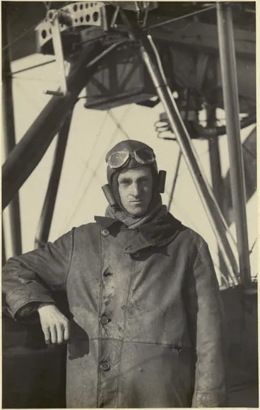 Black and white photograph of George Bolt standing next to a Walsh Brothers Flying School plane, dressed in pilot's clothing Image: Black and white photograph of George Bolt standing next to a Walsh Brothers Flying School plane, dressed in pilot's clothing
