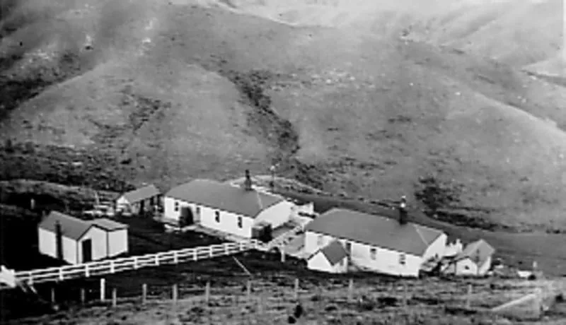 Photograph: Two houses in a valley at Pencarrow