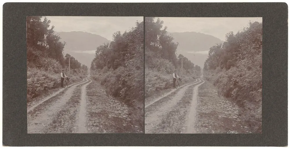 Man with bike on gravel road