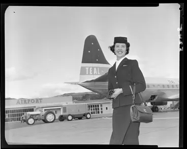 Image: Air hostess [Miss Clark] in front of Teal plane