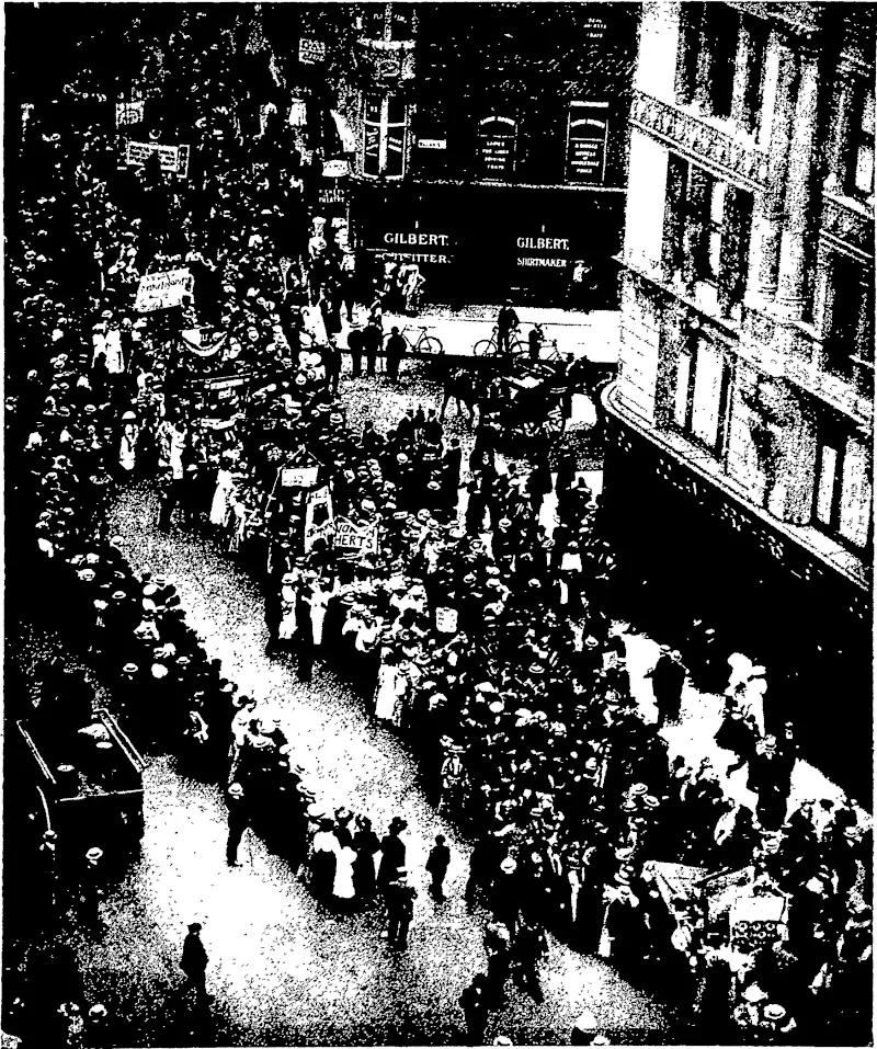A "MONSTROUS REGIMENT OP WOMEN": PROCESSION OP SUFFRAGETTES IN LONDON.  One -wonders nowadays -what John Xnox~ whose words we have quoted above, would say to the movement in England for women's suffrage. Whether one agrees with their principles or not, it is impossible not to admire the forceful, determined, and businesslike manner in which, the women are conducting their^ aeitation. Prom the small scuffle with the police at Parliament Square, the movement has grown to the dimensions shown in our photograph. Ten thousand women, many of them in the robes of doctors i-nd other learned professions, marched in procession to the Albert Hall. ' , —Photo, by Halftones, Lt& (Otago Witness, 05 August 1908)