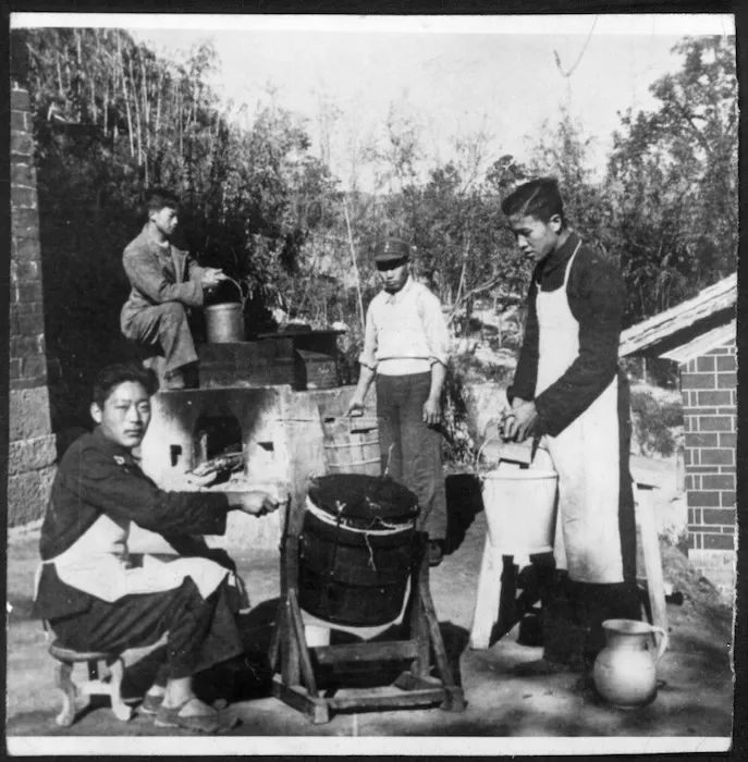 Four men making butter