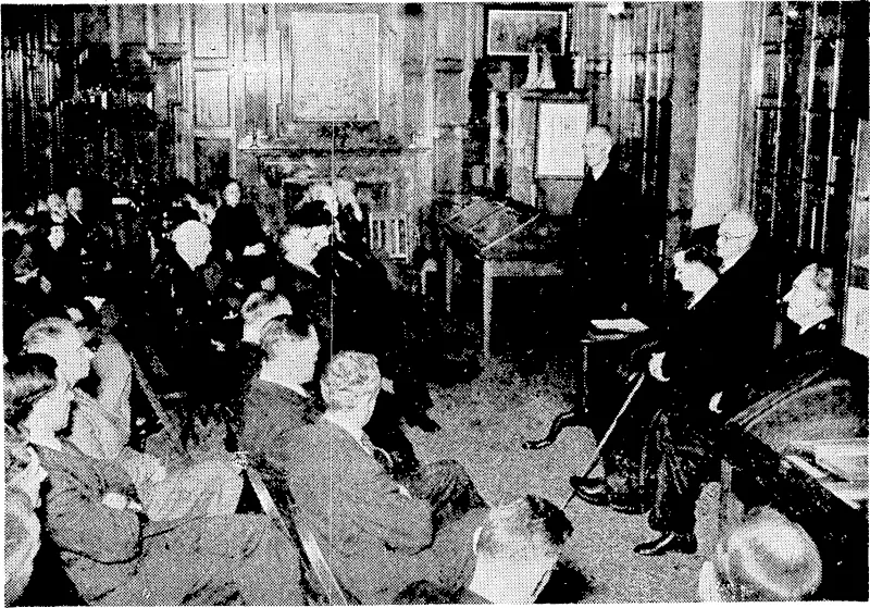 To mark the jubilee of the opening to the.public of the Turnbull Library, Bowen Street, Wellington, a gathering took place on Thursday afternoon in the Library. Amongst the speakers ivas the Minister of Education, Mr. H: G.R. Mason, seen standing on the right. (Evening Post, 07 July 1945)
