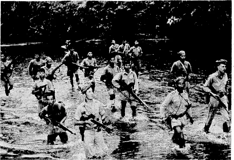 Chinese and Burmese scouts, accompanied by two American soldiers, cautiously wading a jungle stream in Northern Burma. The detachment is part of the Allied Fourteenth Army,, which is composed of British, American, and Chinese soldiers and Burmese patriots. This army has been engaged for some months in hacking its way through the jungles of Japanese-held Burma. (Evening Post, 17 May 1944)