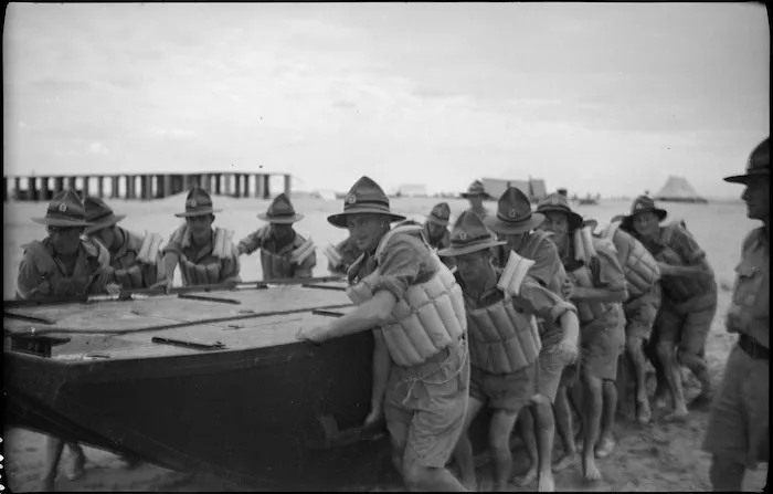Engineers dragging pontoon into water to begin bridge building, Egypt