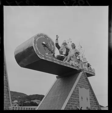 Image: James Smith's Christmas Parade with Father Christmas and a young girl elf on a sleigh, Wellington Region