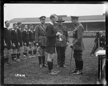 Image: King George V presents a cup to the captain of the winning New Zealand Services Rugby Team, London