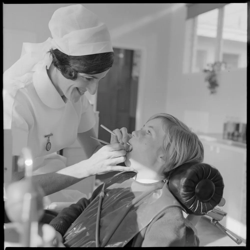 Tauranga Intermediate School Dental nurse J.T. Cook examining Barbara Faulkner.