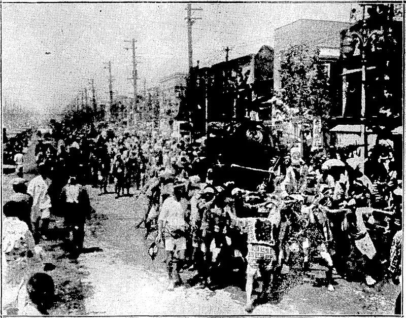 Sport and G«ner*l"-Photo. ON THE'ROAD^TO AN ANCIEI U JAPANESE SllßlNEL—Colourful scenes iverc wiinessed:hin;T6jko recently duringdhe elaborate jest l .... . man" Shrine, at Fukagawa, near Tokio; ThejphotO' graph, taken?on the final day of the jcstival, shows the\,Sacred Palan-juin being shouldered'byiyoung. men, during itJieiprocession through the streets of'Tokio^The Japanet; wear their native[-costumes i-and : follow an -elaborate-rituat, ■ ■__ v^_^_ \{_. (Evening Post, 23 October 1930)
