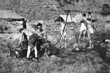 Image: Men of HQ Platoon, 10 Coy, RNZASC, showering in Korea