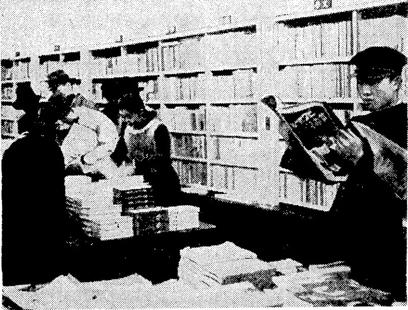 In a Japanese bookshop in Tokio. Crowded bookshelves and intent readers indicate the advances made in education in recent years amongst the people of Japan. . (Evening Post, 07 December 1938)