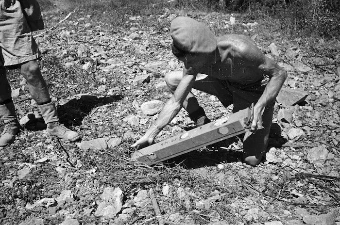 Kaye, George, 1914- (Photographer) : World War 2 New Zealand Engineer locating a new type of anti-vehicle mine in Florence, Italy