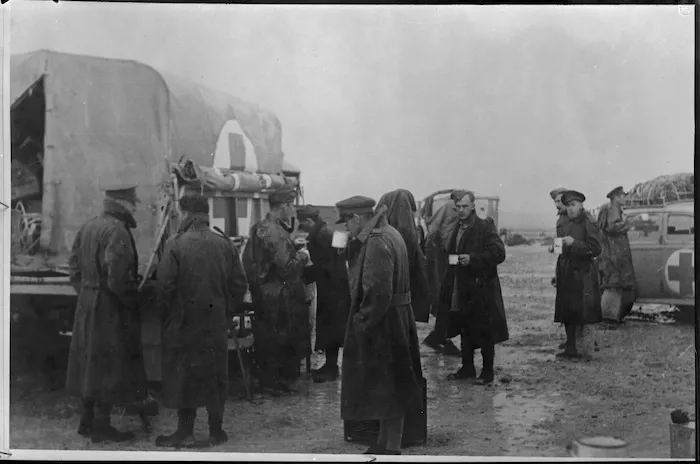 Members of a NZ casualty clearing station stop for tea in wet weather at Sidi Haneish, Egypt, World War II - Photograph taken by Major Wilson