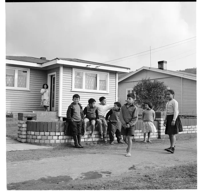 Houses, possibly Ngaruawahia; Para Matchitt sculpting on the porch of his house, Hamilton