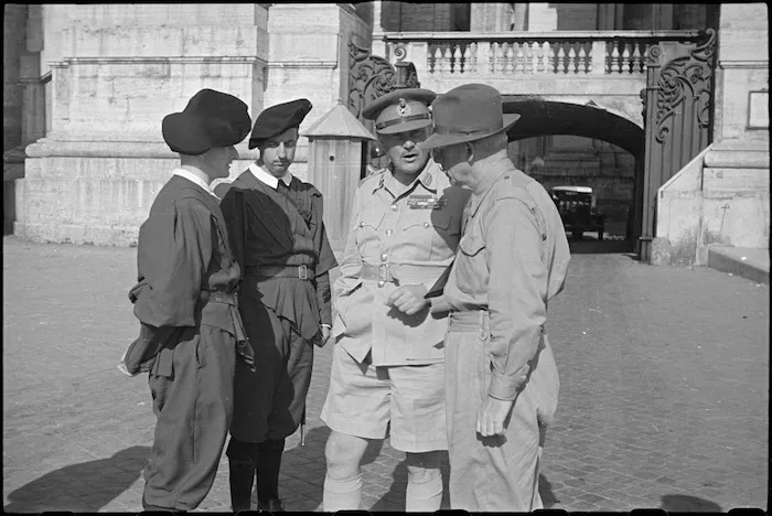 Prime Minister Peter Fraser and General Bernard Freyberg talking to Swiss Guards at gates of Vatican, Italy, World War II - Photograph taken by George Bull