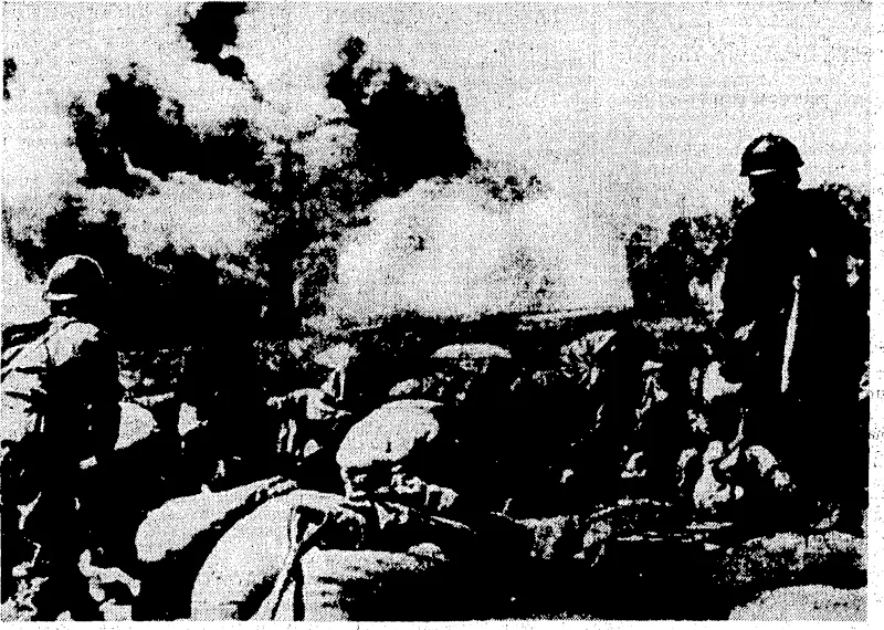 Pictures taken in the front lines of the eastern sectorof the war front at Shanghai, where Japanese troops are seen watching the smoke-enveloped buildings occupied by Chinese. T.hese buildings had just been bombed byJapanese warplanes when thy photographs were taktsn, _ . (Evening Post, 06 November 1937)