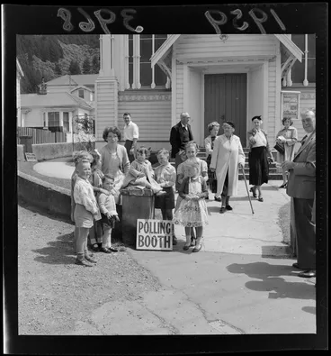 Image: Children and adults standing outside a polling booth at an unidentified church, probably in the Wellington region