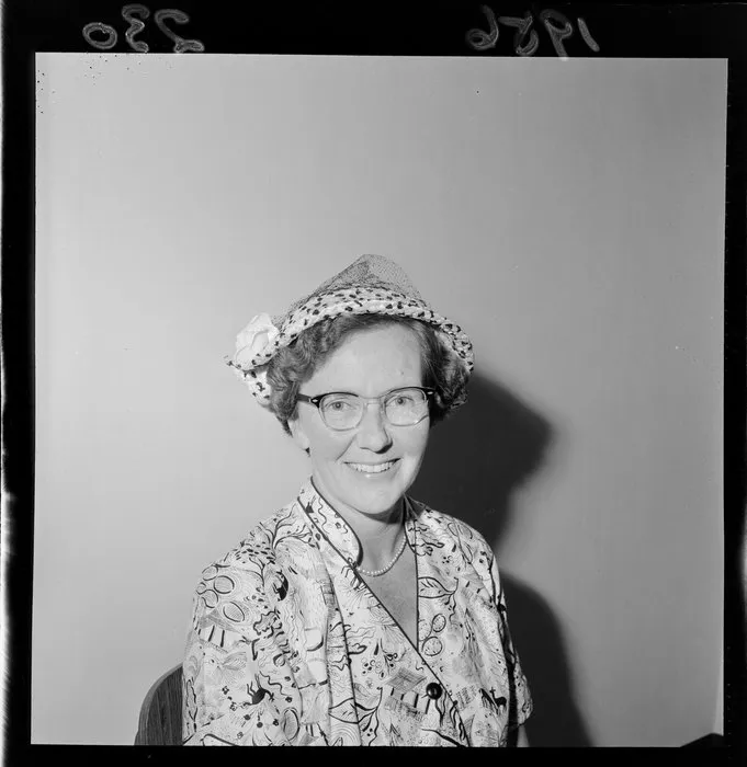 Portrait of Mrs E G Roberts, trainer of hostesses, who wears a hat and glasses
