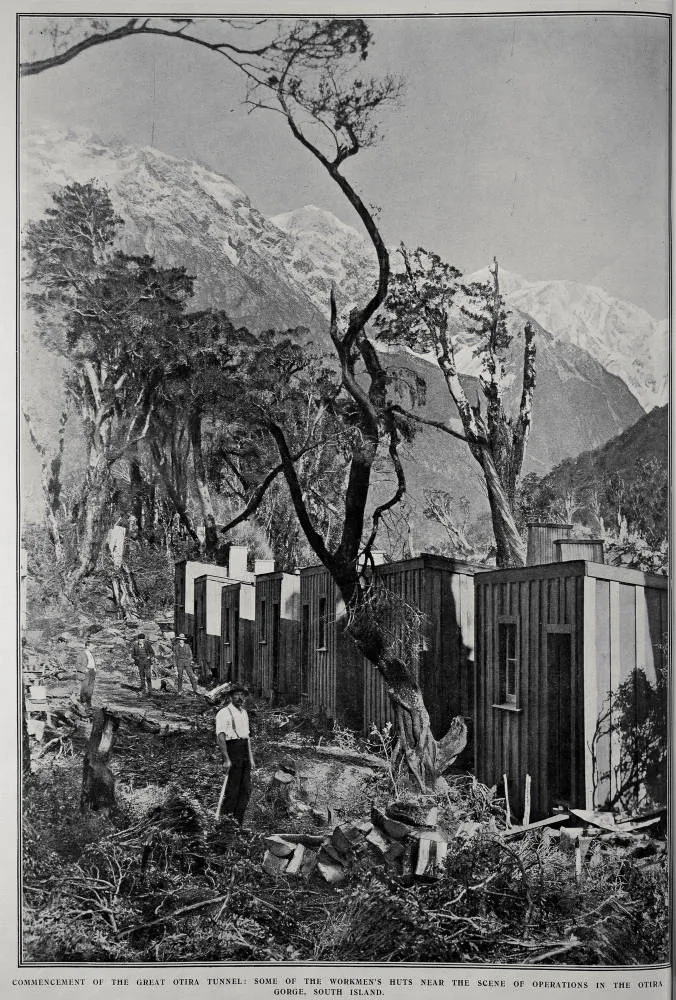 COMMENCEMENT OF THE GREAT OTIRA TUNNEL: SOME OF THE WORKMEN'S HUTS NEAR THE SCENE OF OPERATION IN THE OTIRA GORGE, SOUTH ISLAND
