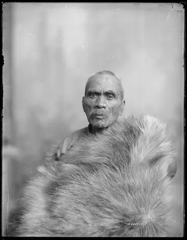 Image: Unidentified elderly Maori man and animal skin cloak, Wanganui region - Photograph taken by Frank J Denton