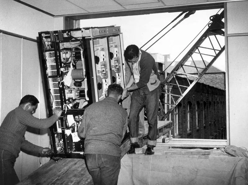 Winstone Ltd - Head Office, 69 Queen St, Auckland: 1966 Installation of the ICL Series 1500 computer - unloading computer onto third floor through window