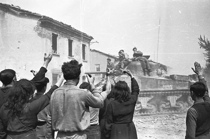 Kaye, George, 1914- : Inhabitants of the town of Barbiano, Italy, greeting entering NZ tanks