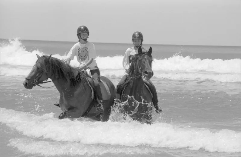 Amy Wilder from Waipukurau and Margot Lowry of Hastings riding horses in the surf