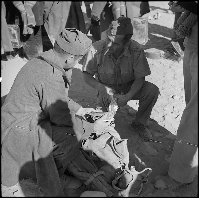 NZ officer examining possessions of Italian POW